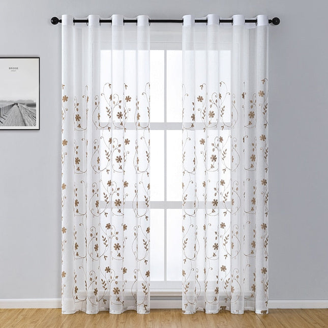 Tunn gardin med broderade blomrankor