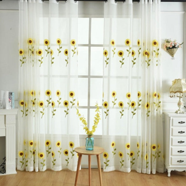 Tunn gardin med broderade solrosor